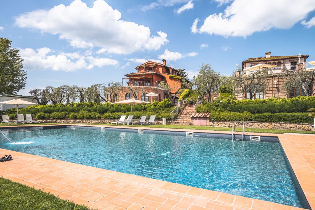 Stunning mansion with a pool and lush garden setting, ideal for summer vacations.